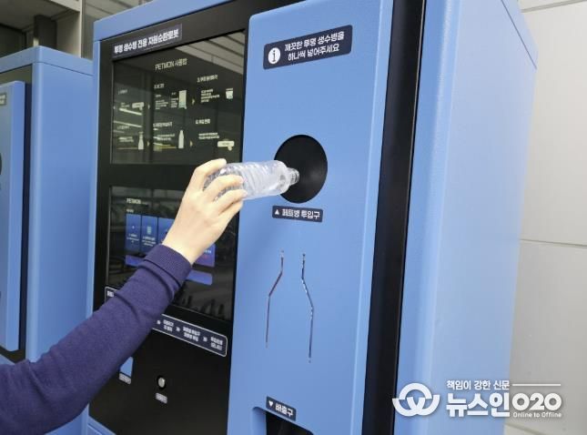 수원시 관계자가 투명페트병 무인회수기에 페트병을 투입하고 있다.